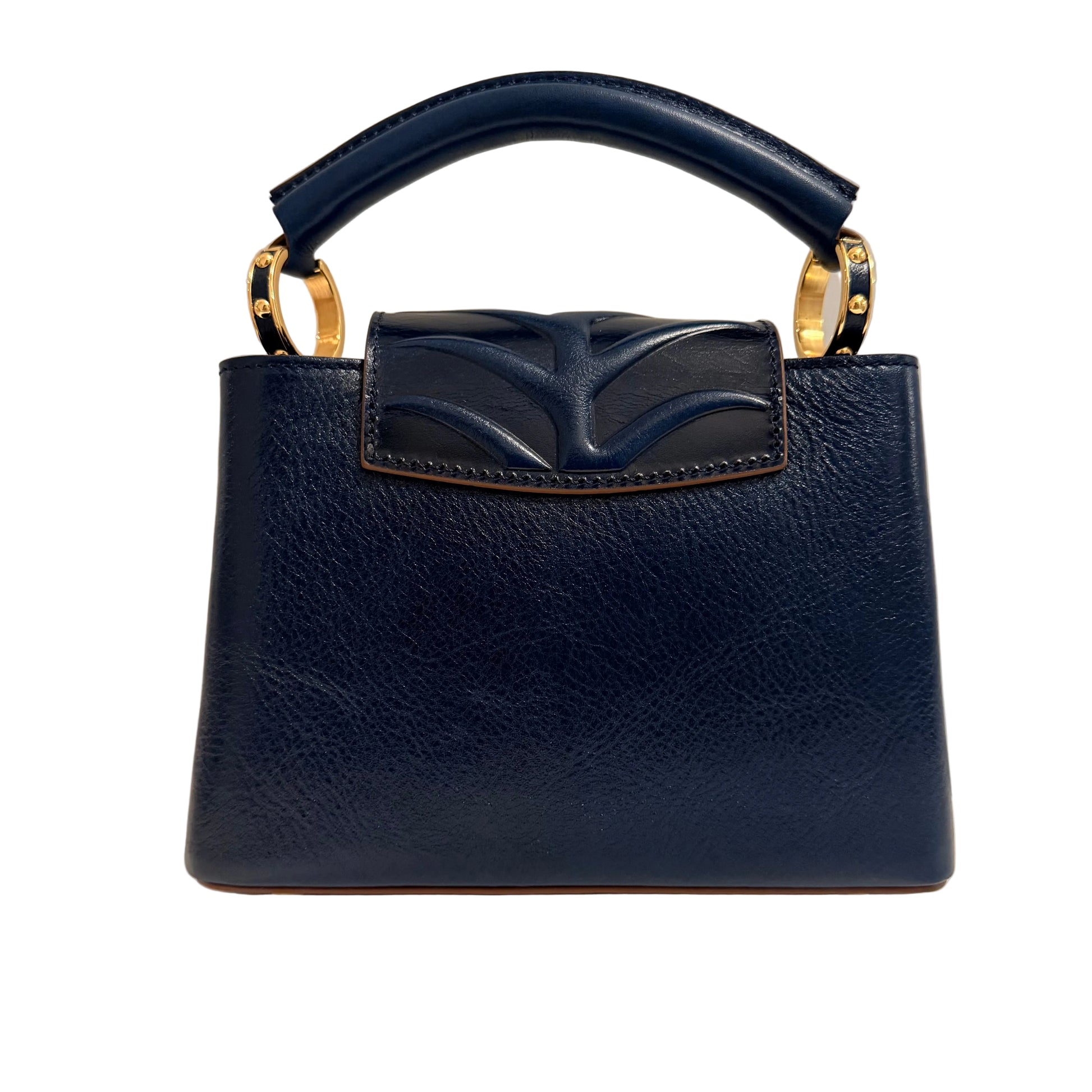 Navy blue handbag with gold accents on a beige background