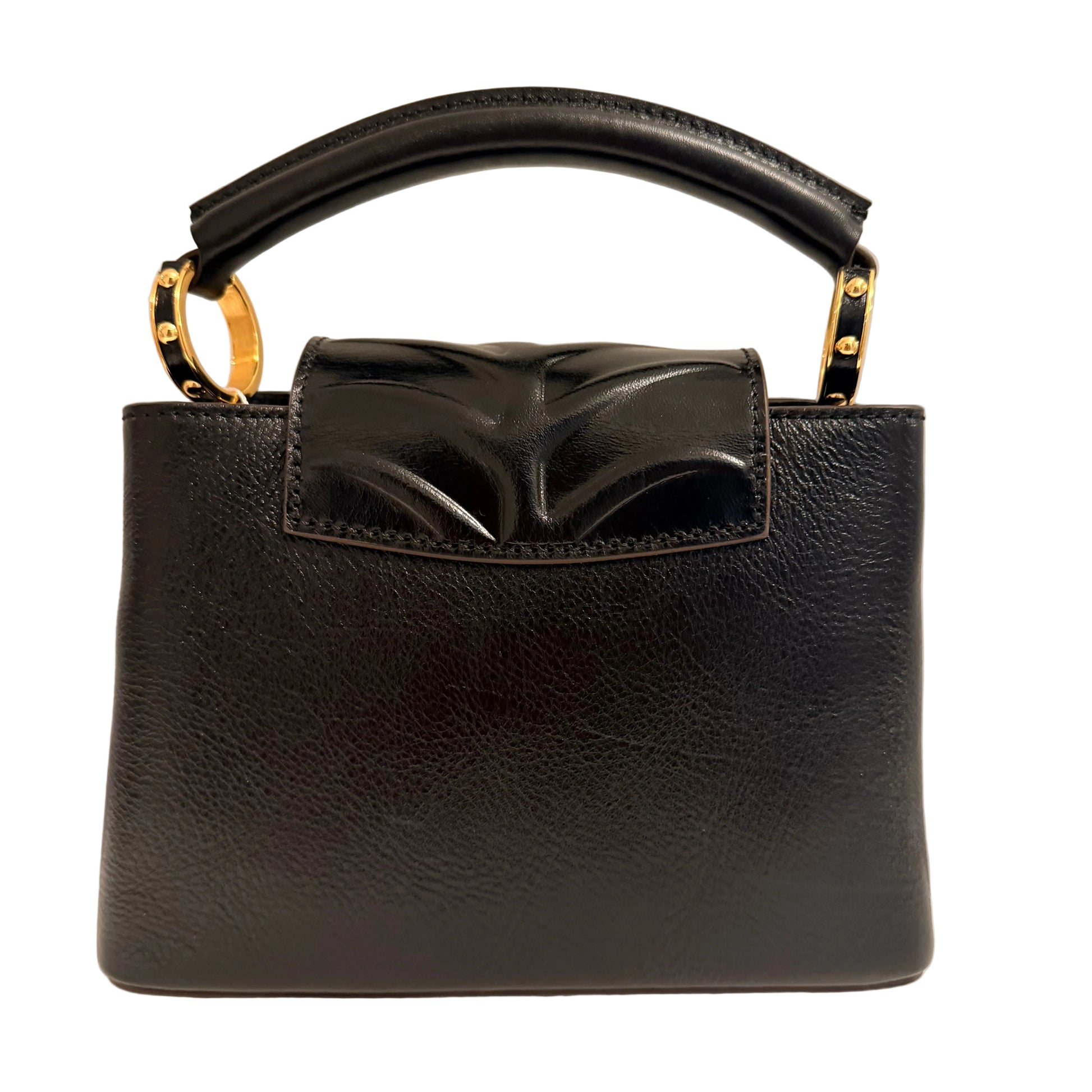 Black handbag with a decorative bow on a beige background