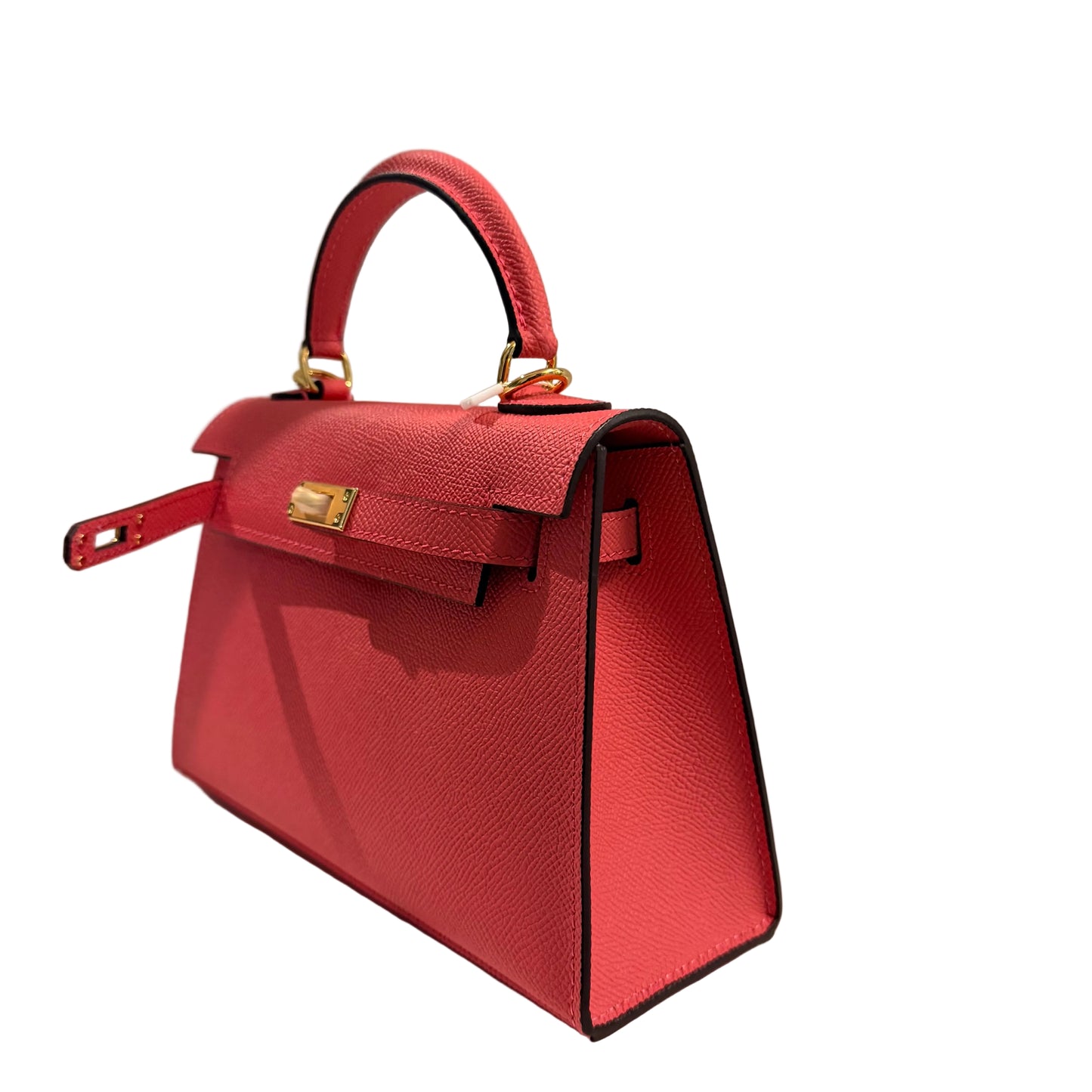 Red handbag with gold accents on a light gray background