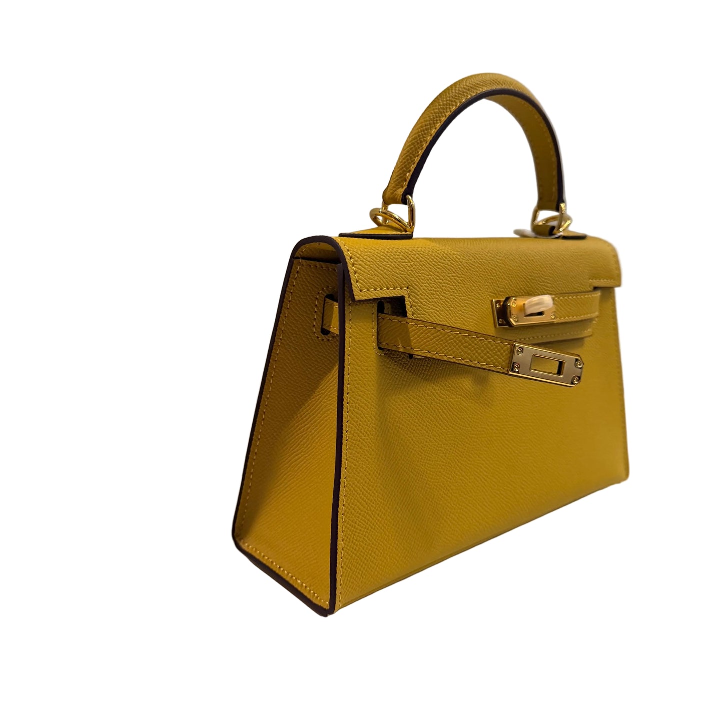 Yellow handbag with gold hardware on a light gray background