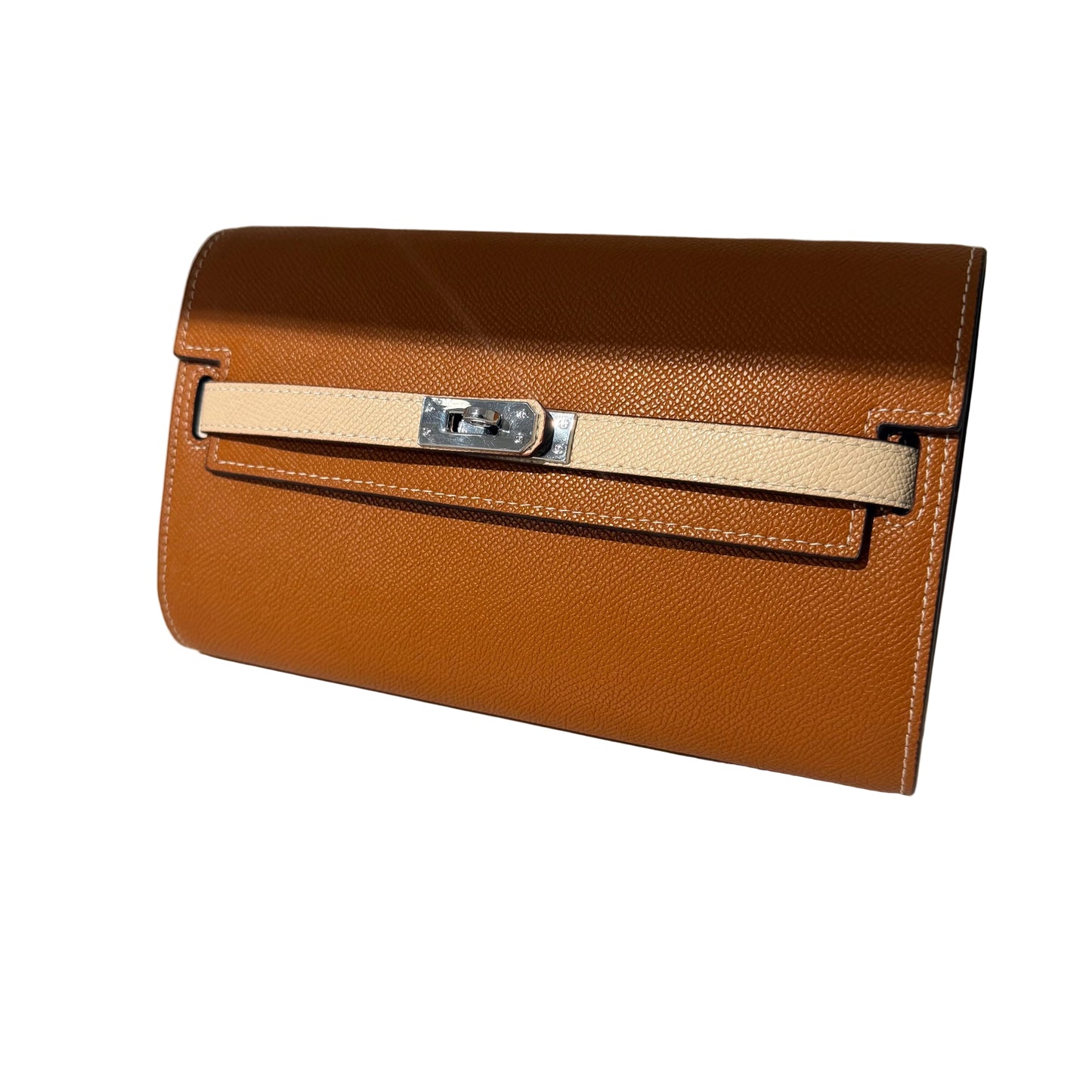 Brown leather clutch bag with a beige strap on a light background