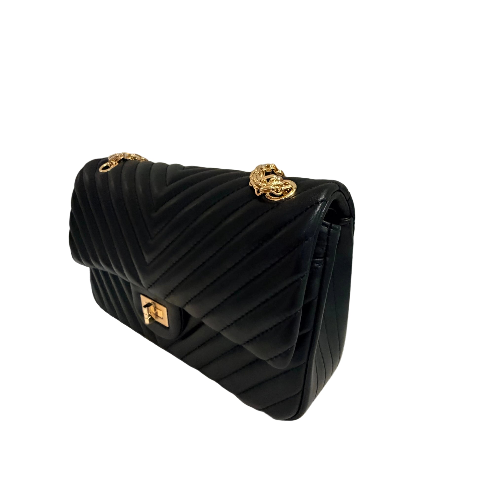 Black quilted handbag with gold accents on a light gray background