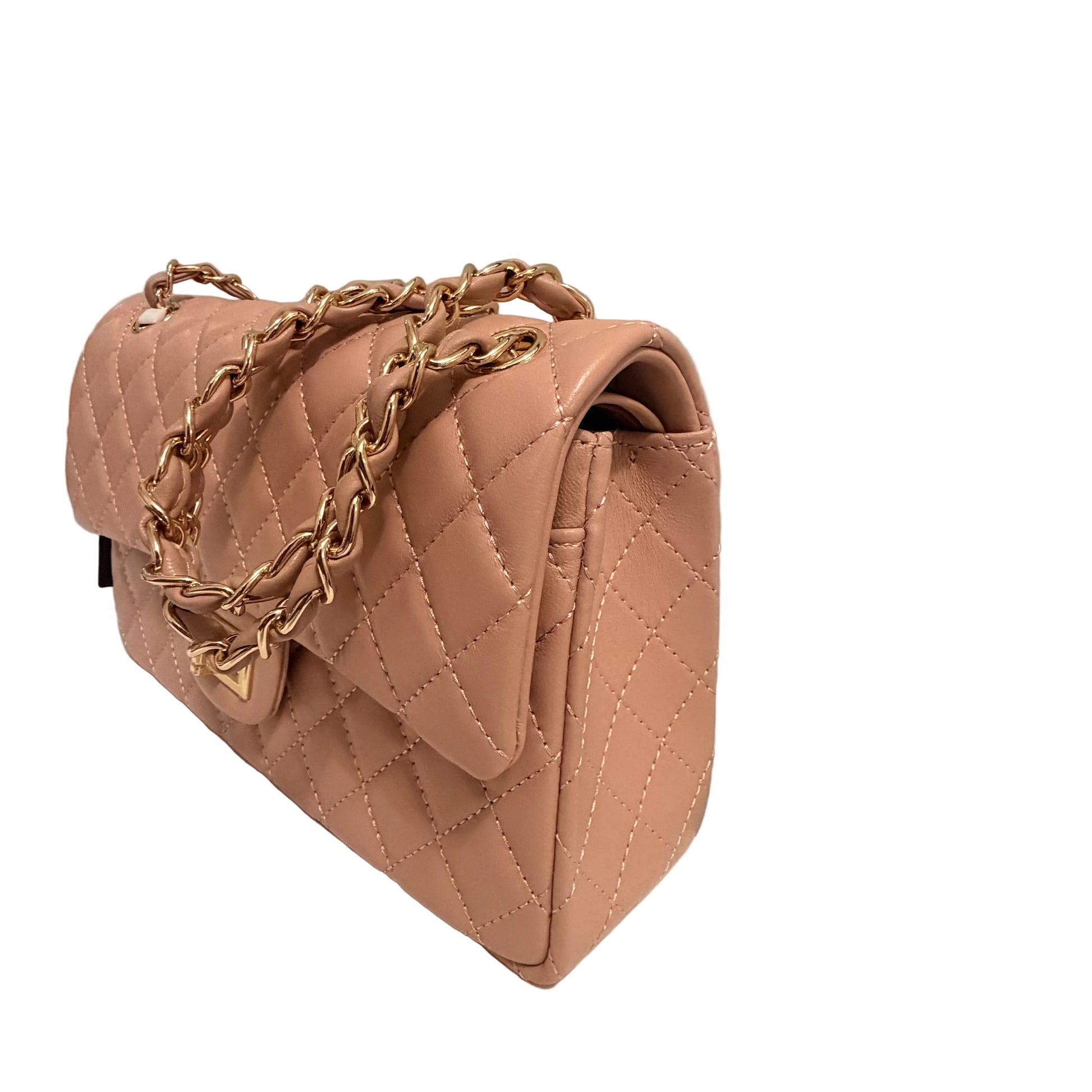 Pink quilted handbag with gold chain on a white surface and gray background