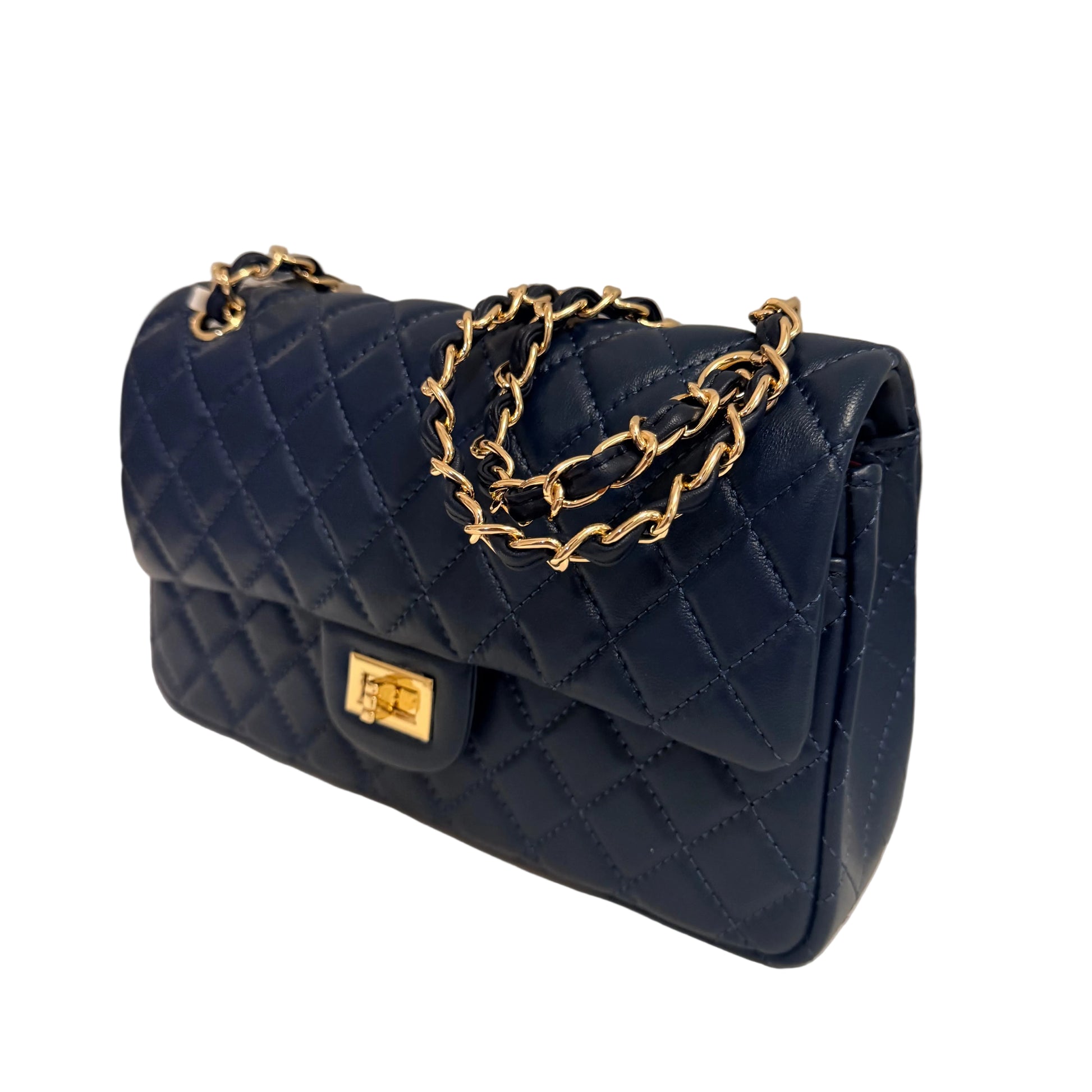 Navy blue quilted handbag with gold chain and clasp on a light gray background