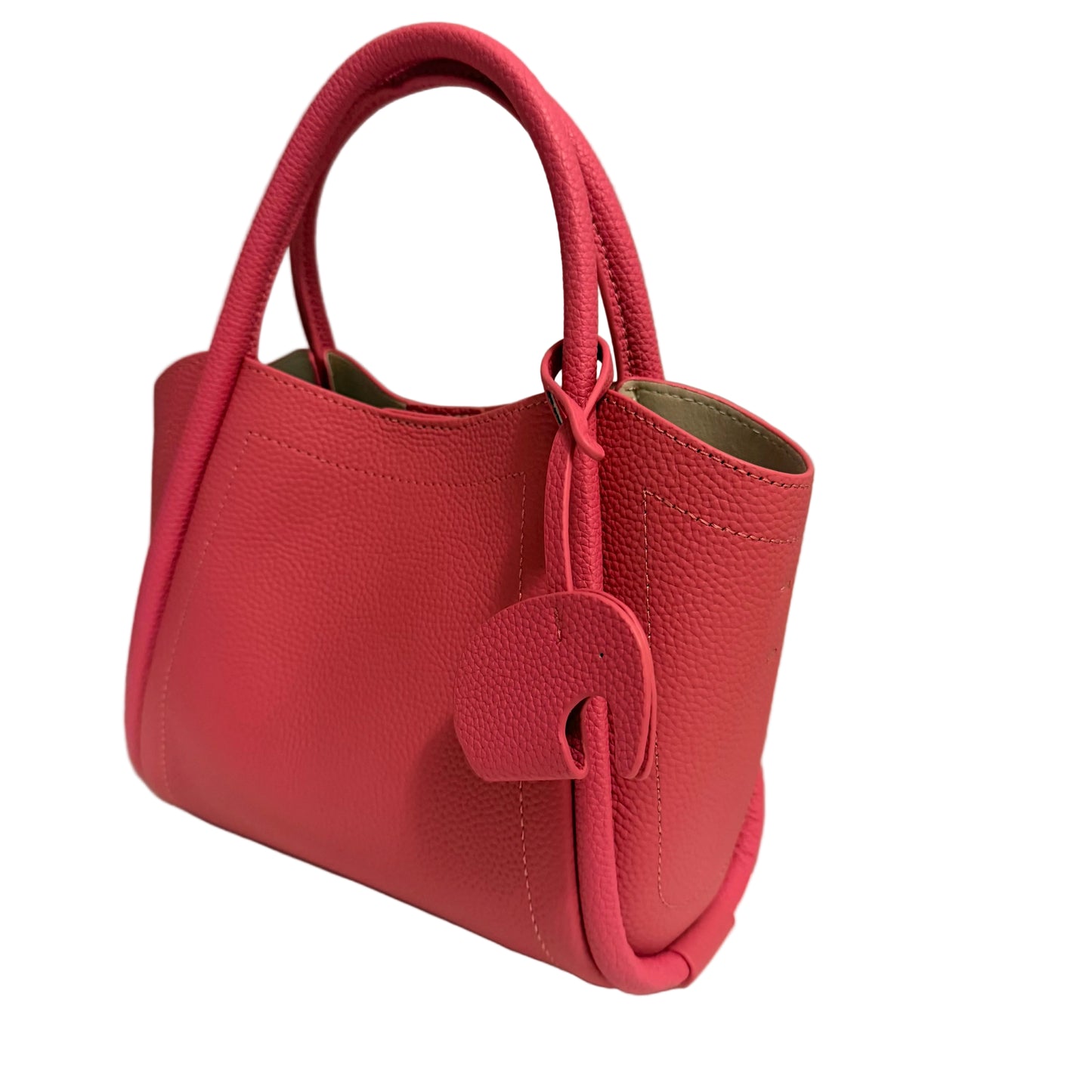 Red handbag on a white surface with a gray background