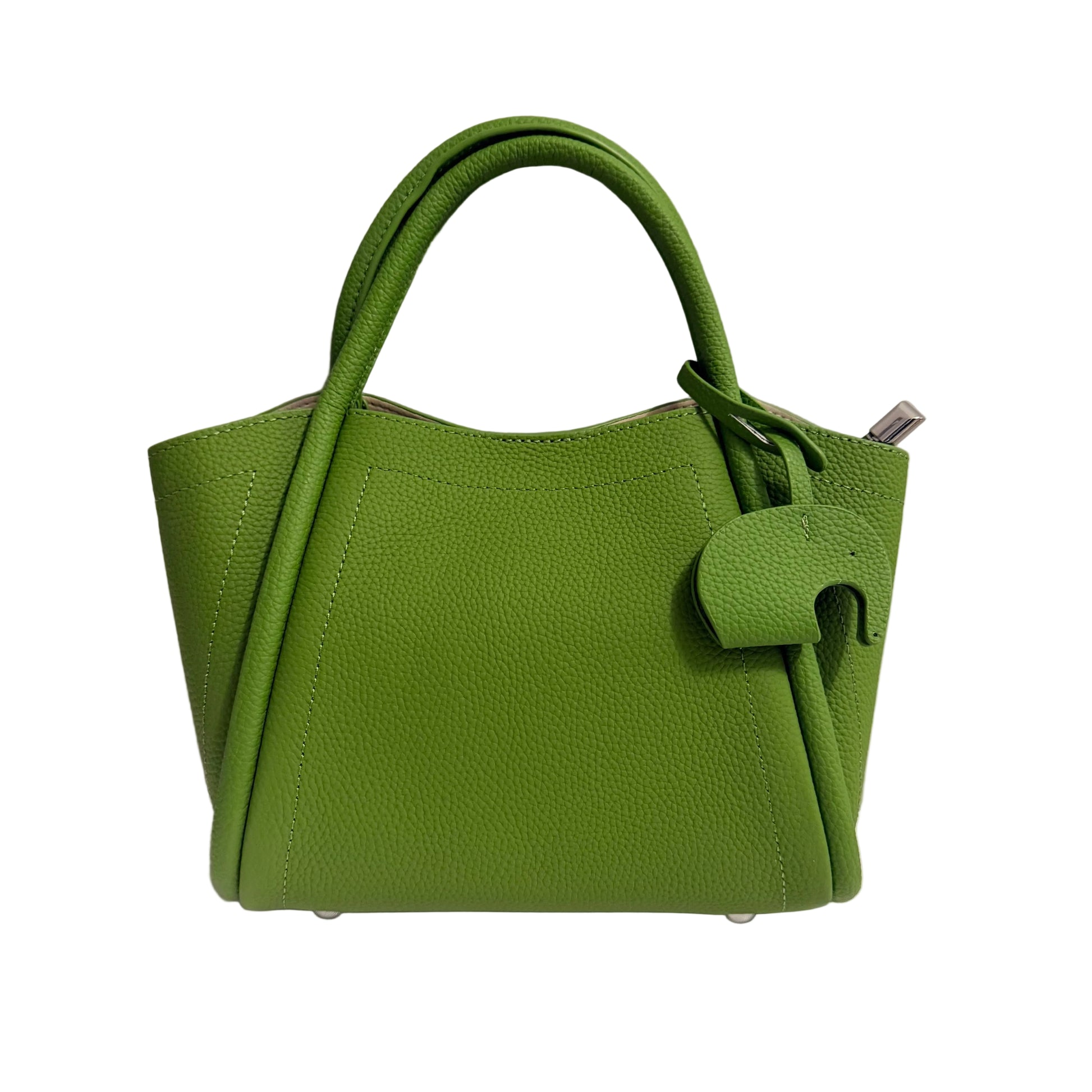 Green handbag on a white surface with a light gray background