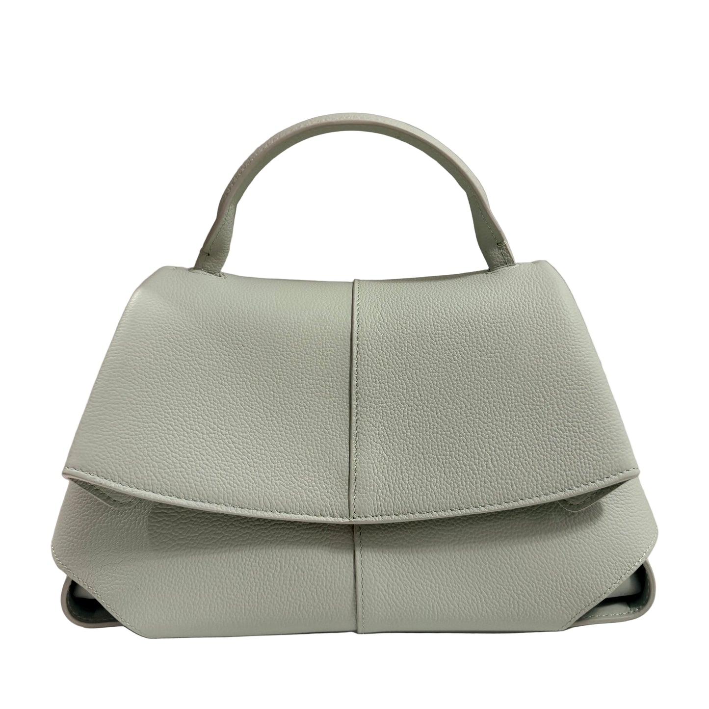 Light green handbag on a white surface with a beige background
