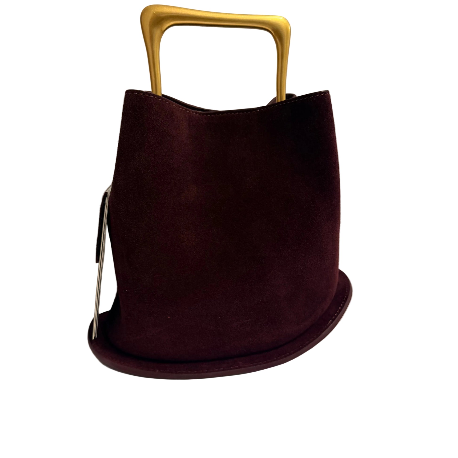 Brown handbag with a gold handle on a white surface
