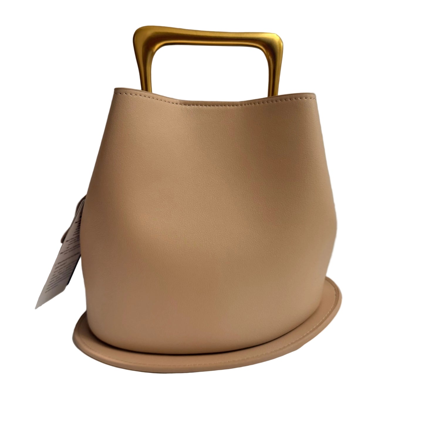 Beige handbag with gold handle on a white surface