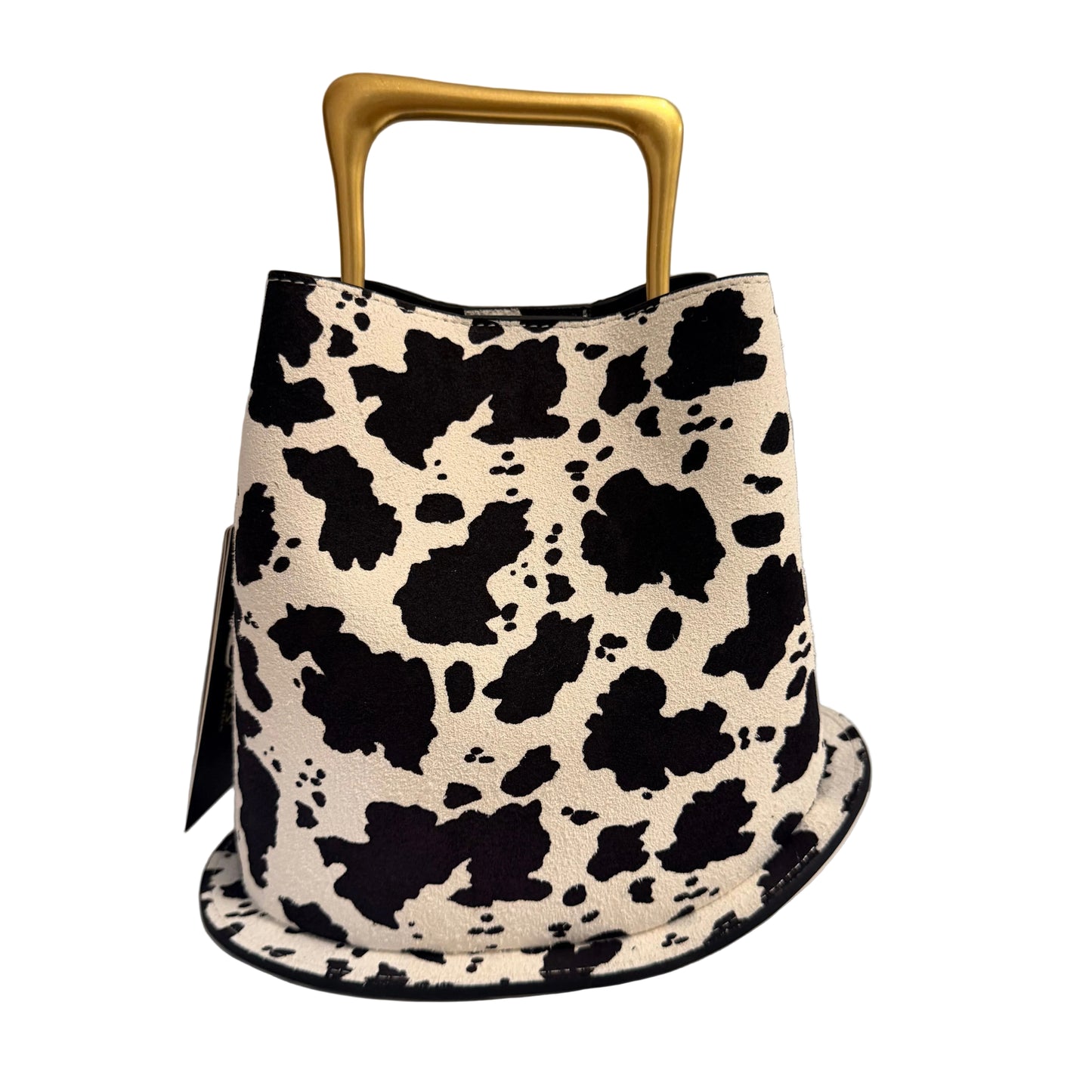 Handbag with cow print pattern and gold handle on a neutral background