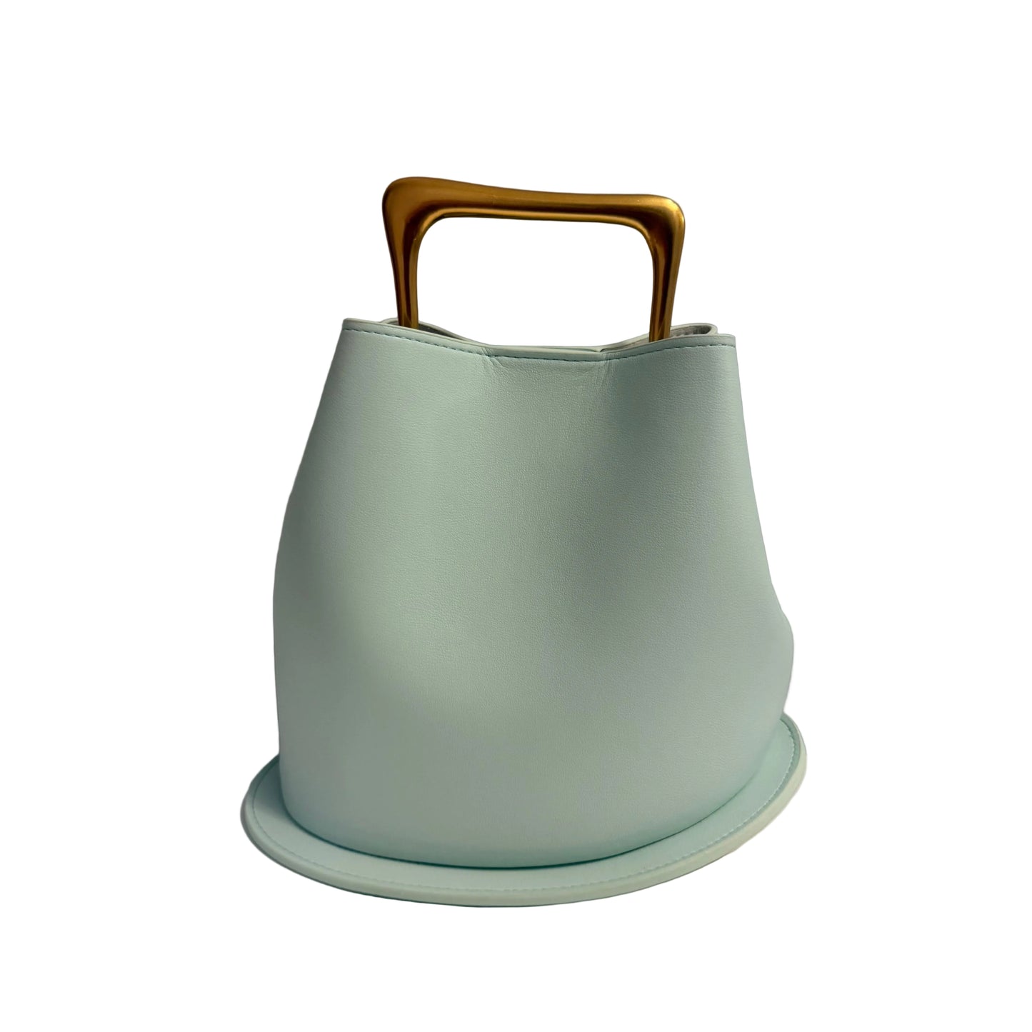 Light blue bucket with a gold handle on a white surface and gray background