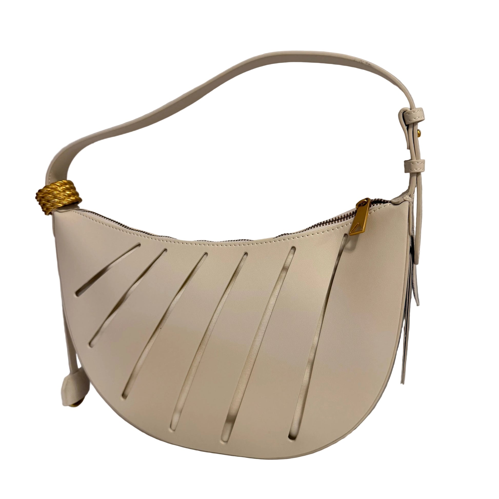 Beige handbag with gold accents on a white surface against a gray background