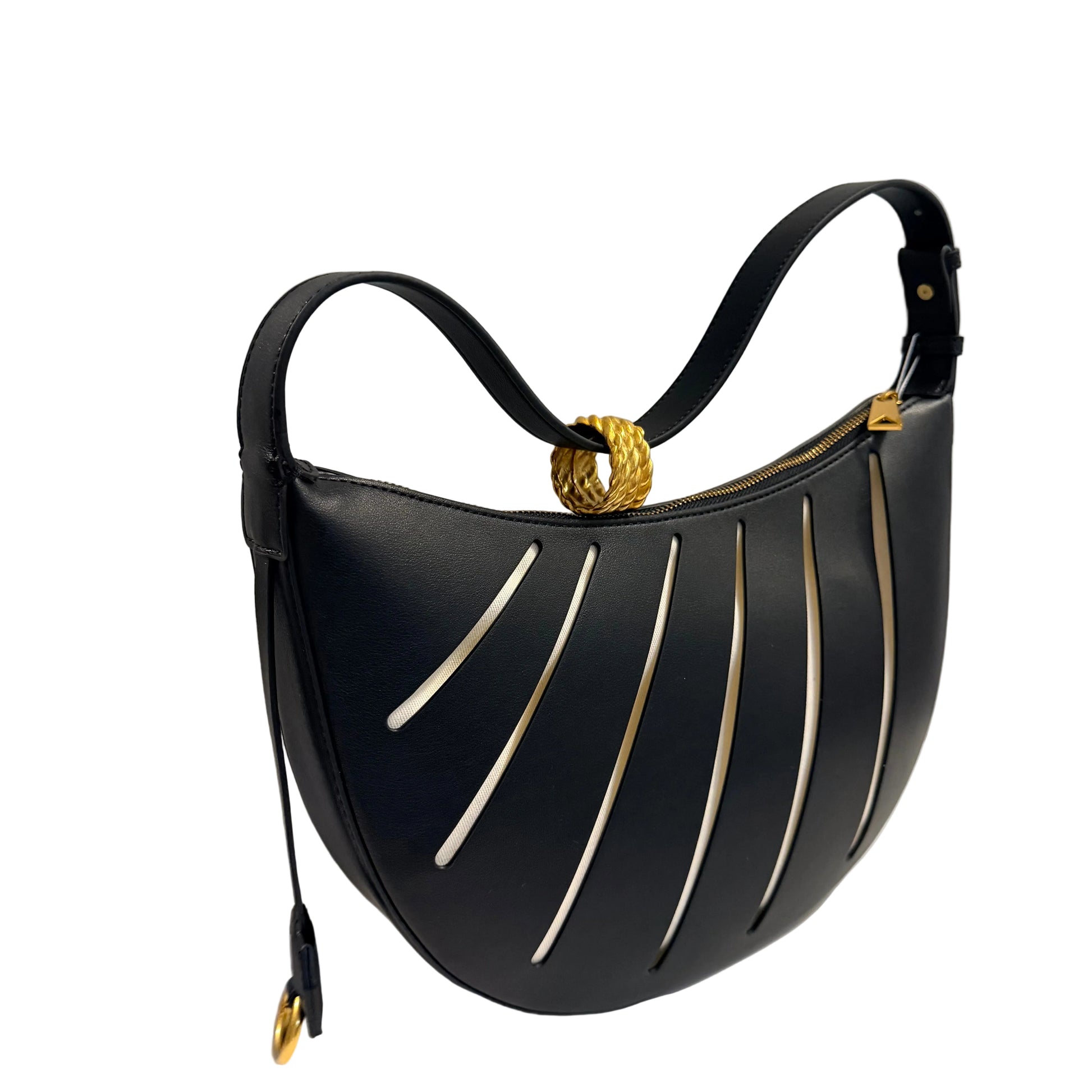 Black handbag with gold accents on a white surface