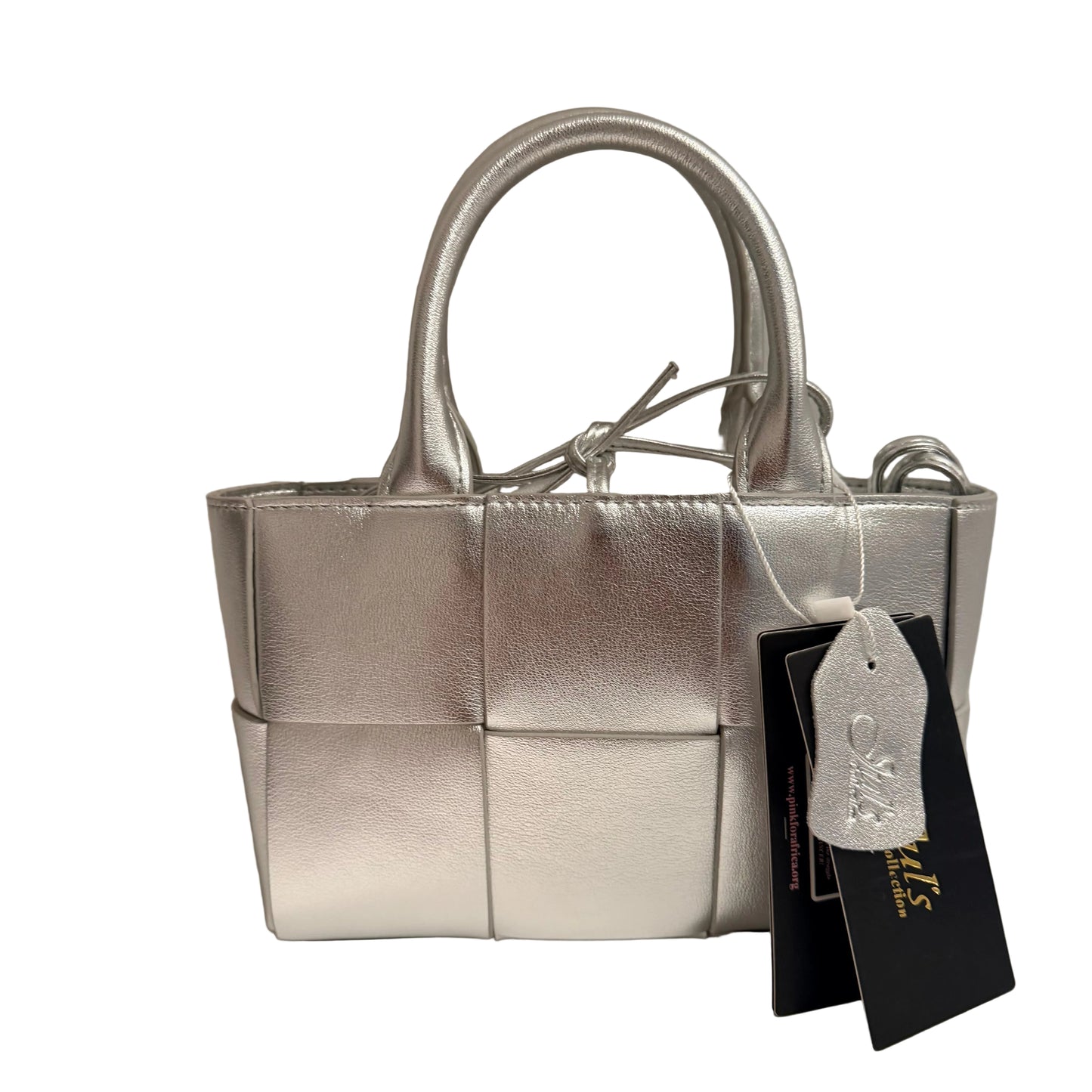 Silver handbag with a tag on a neutral background
