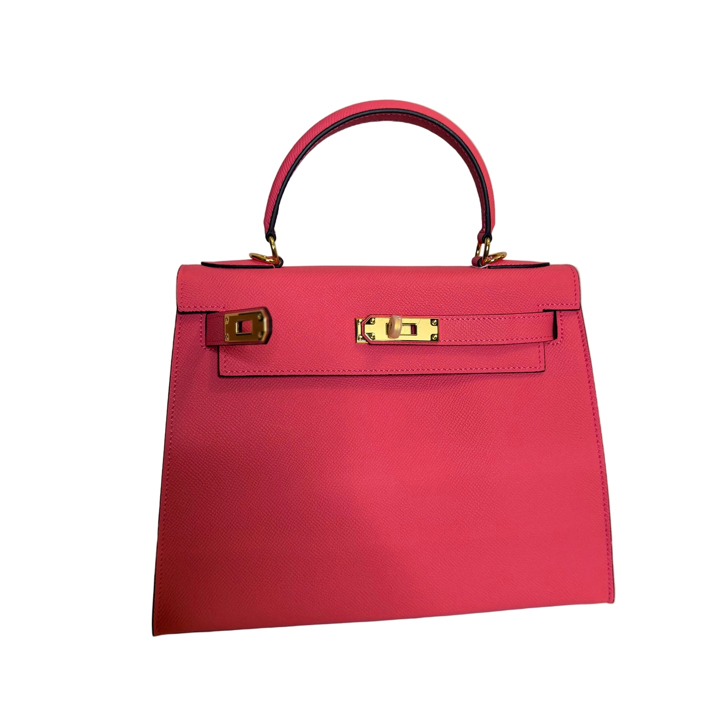 Pink handbag with gold hardware on a light gray background