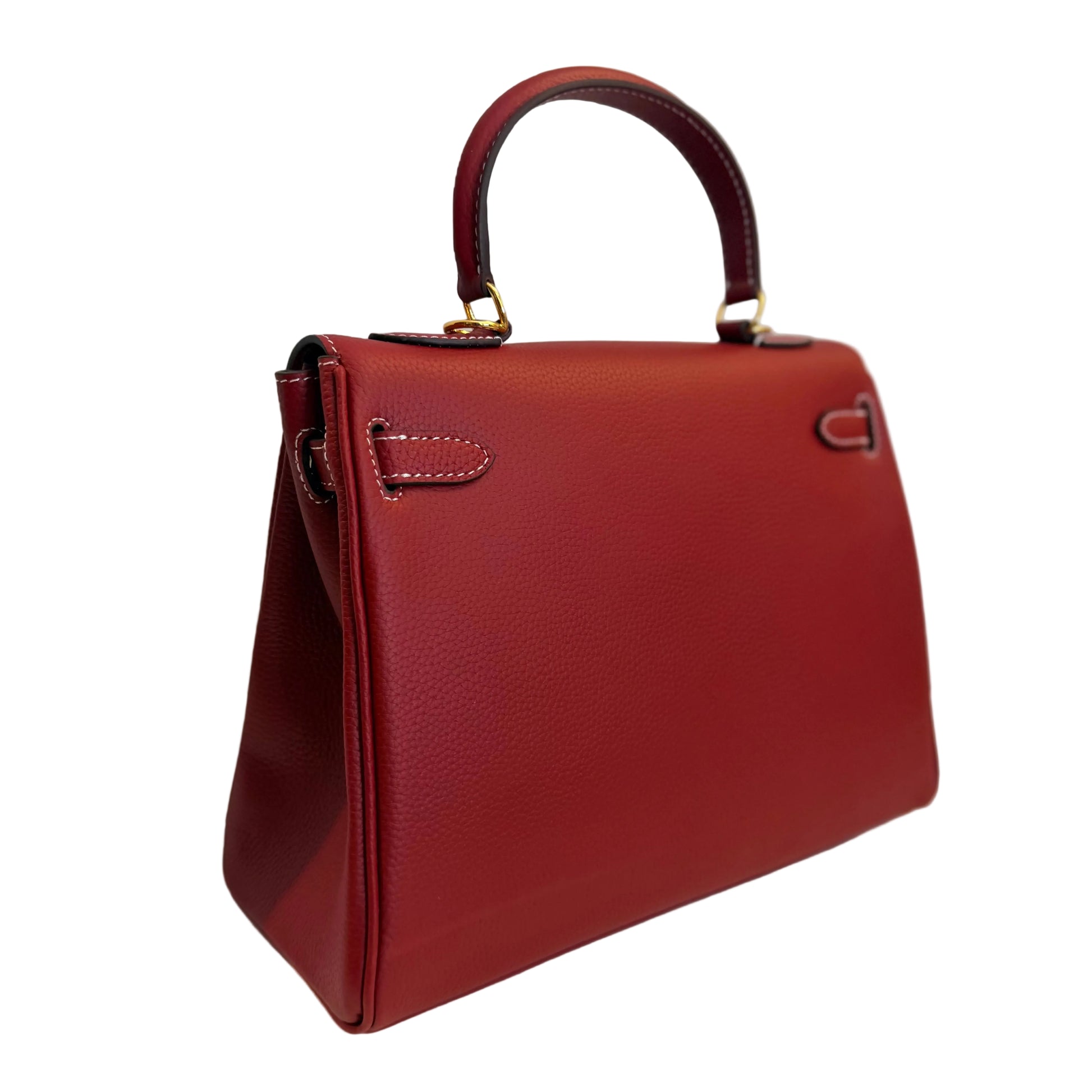 Red handbag on a white surface with a light gray background