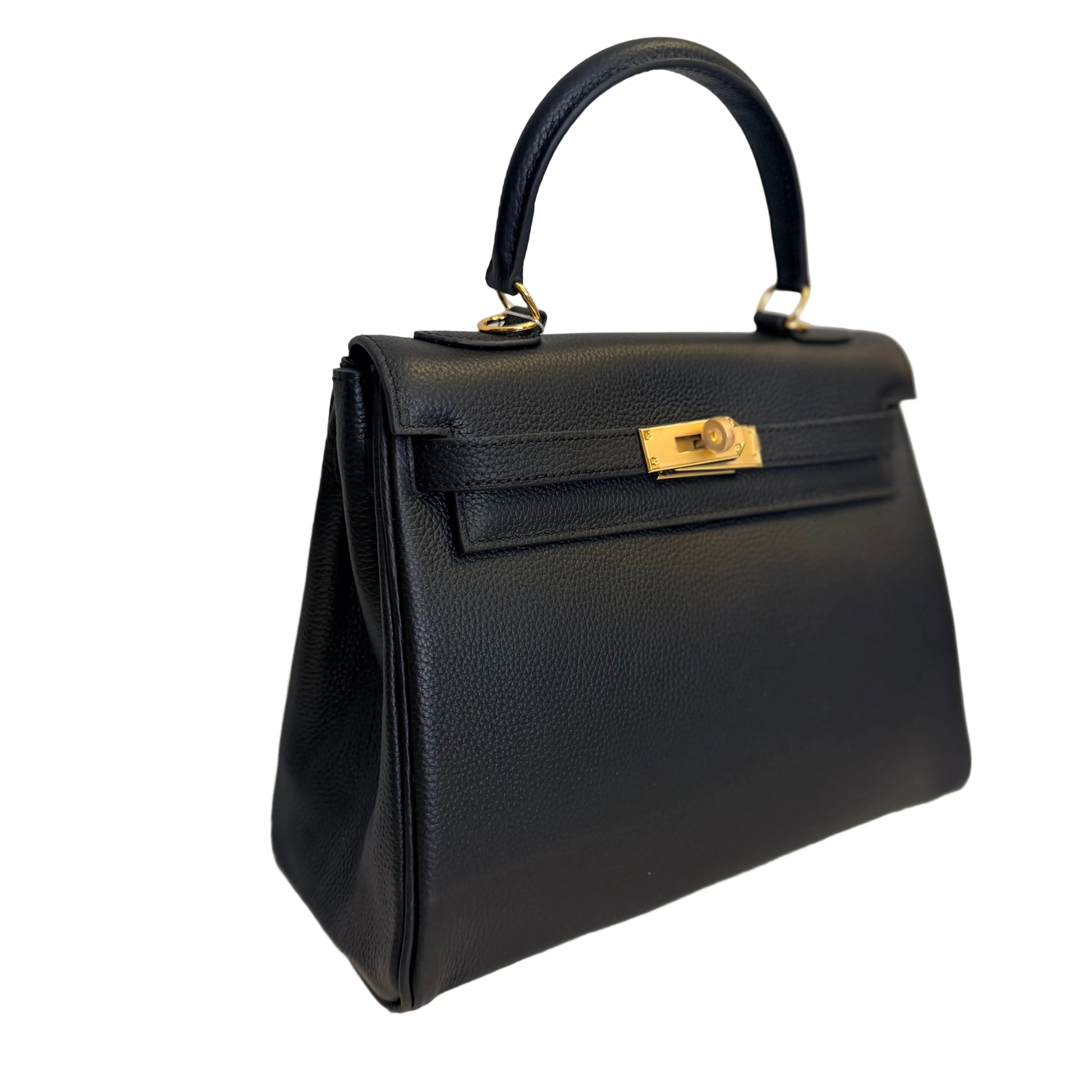 Black handbag with gold hardware on a light gray background