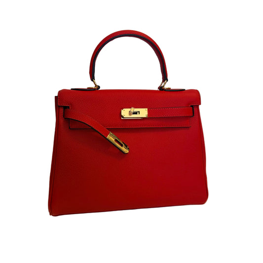 Red handbag with gold hardware on a light gray background