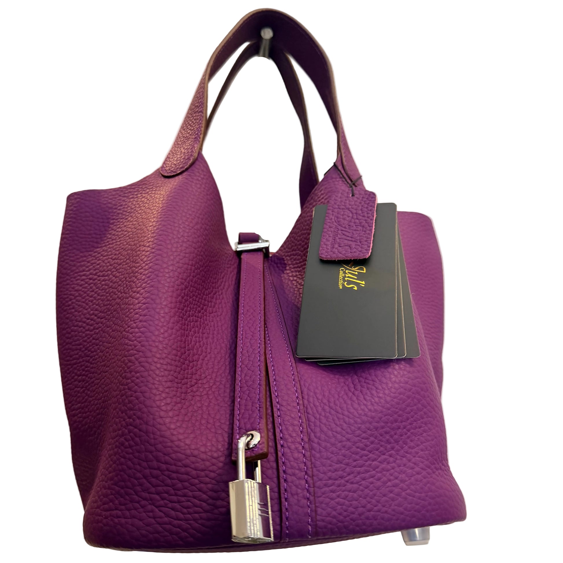 Purple handbag with a visible brand tag on a neutral background