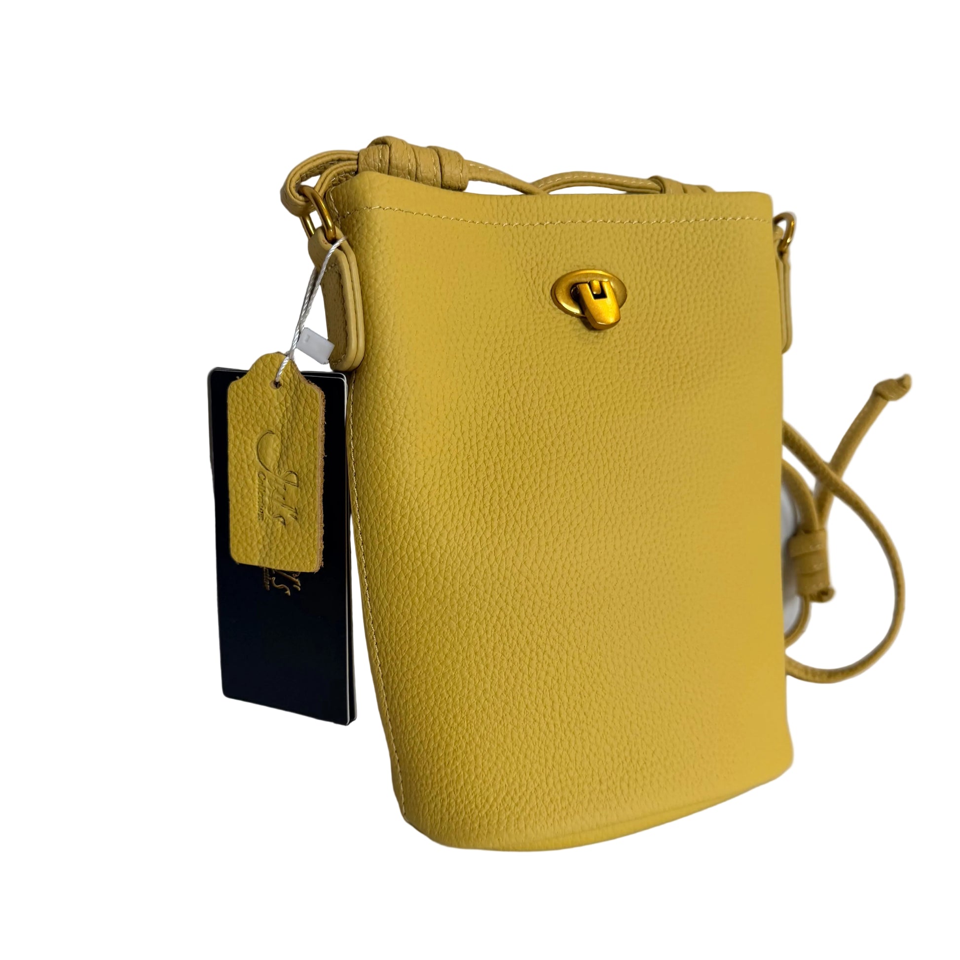Yellow handbag with a tag on a white surface