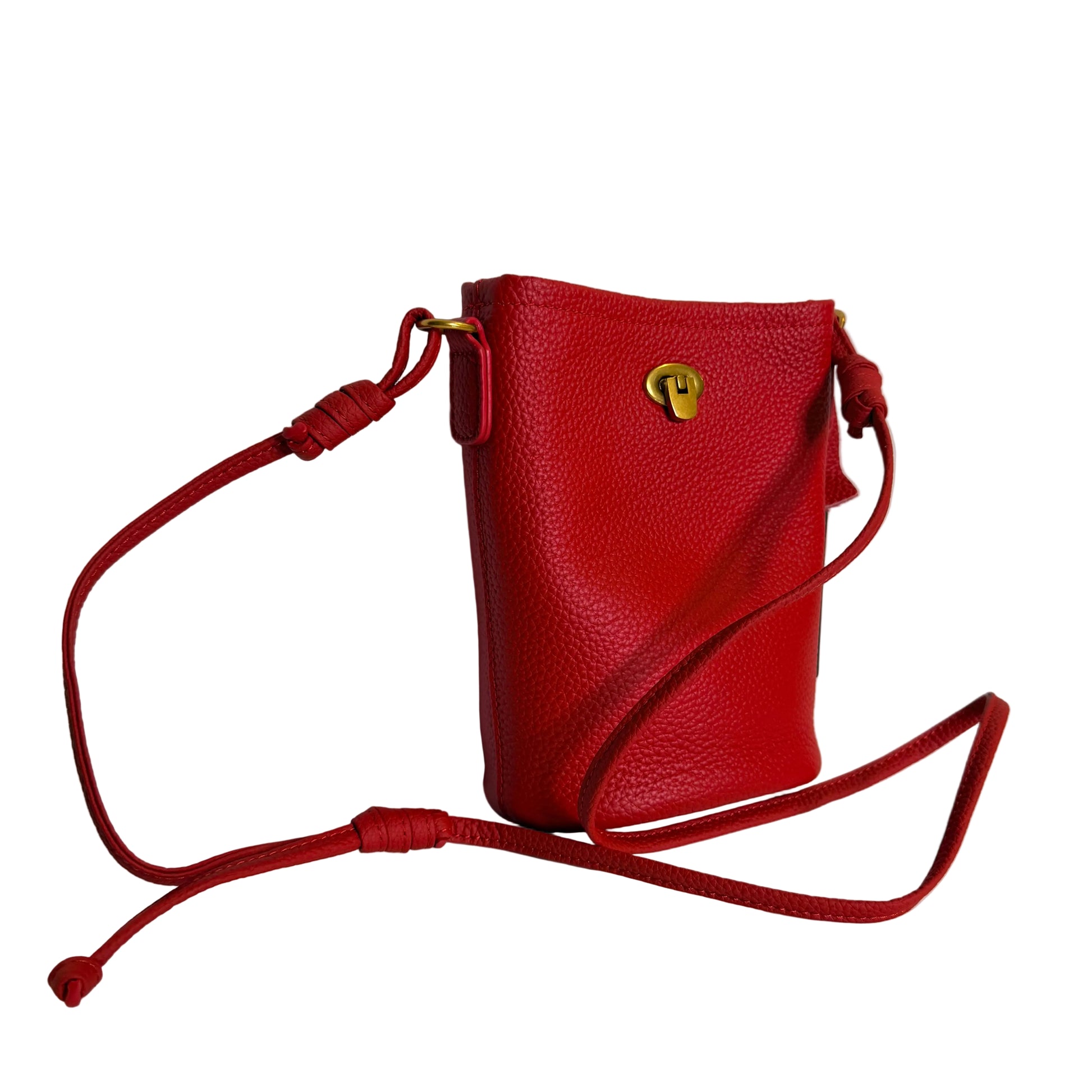 Red leather handbag with a strap on a light gray background