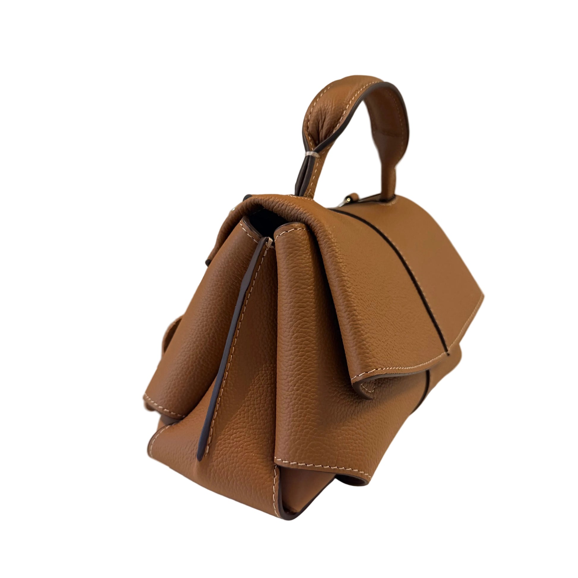 Brown leather handbag on a light surface with a neutral background