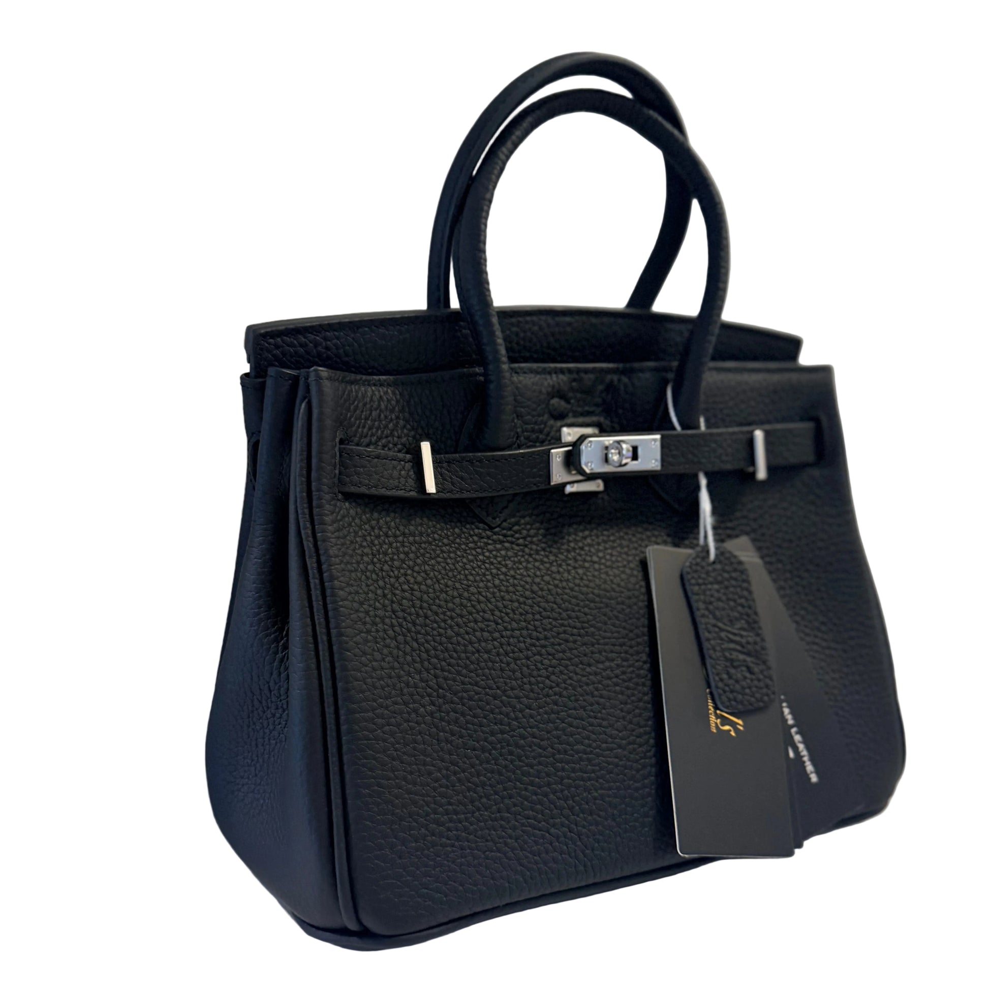 Black handbag with a tag on a white surface