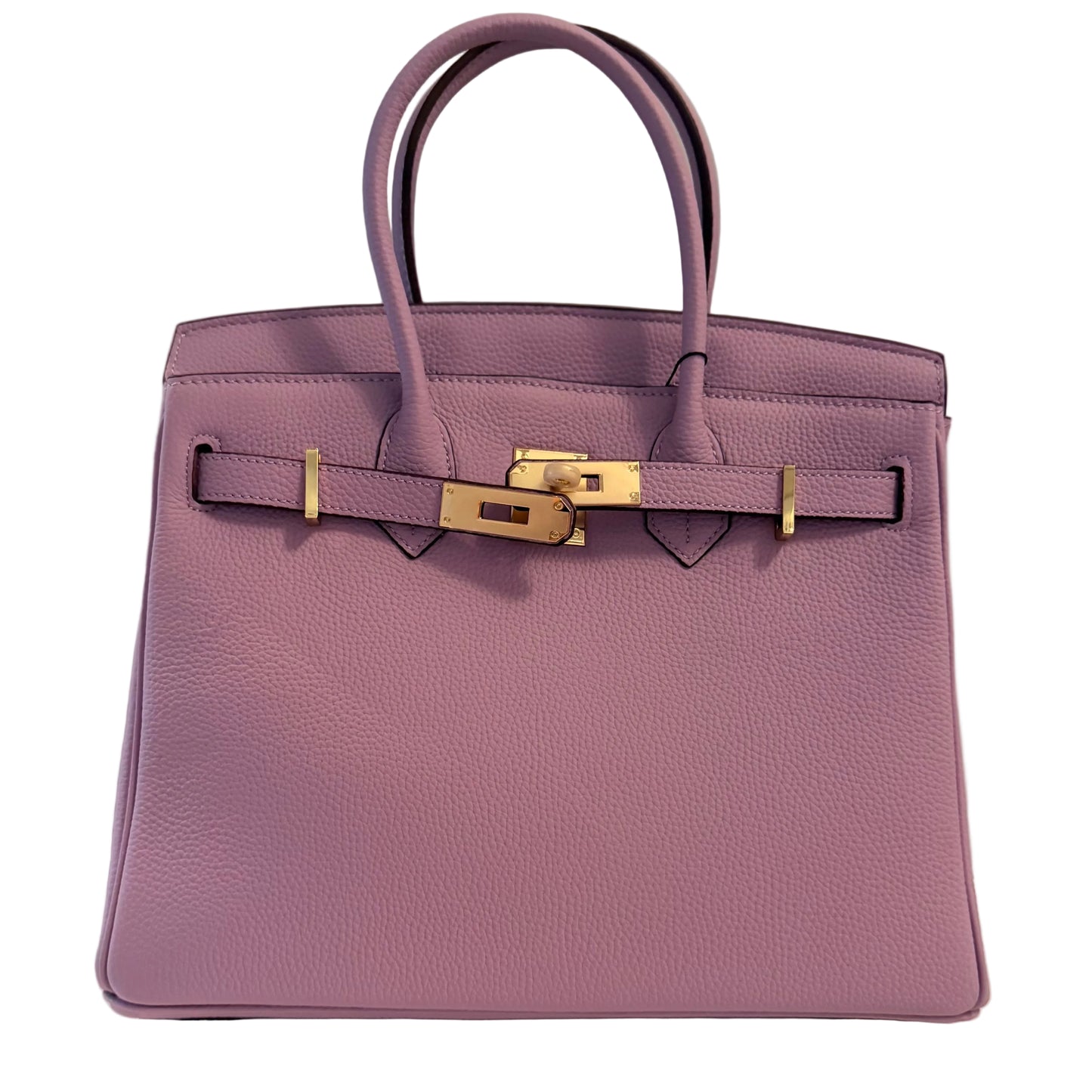Purple handbag with gold hardware on a neutral background