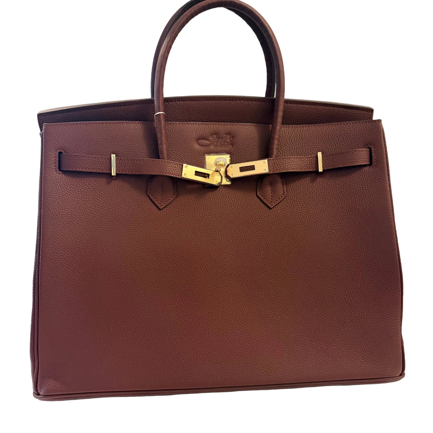 Brown leather handbag with gold hardware on a light background