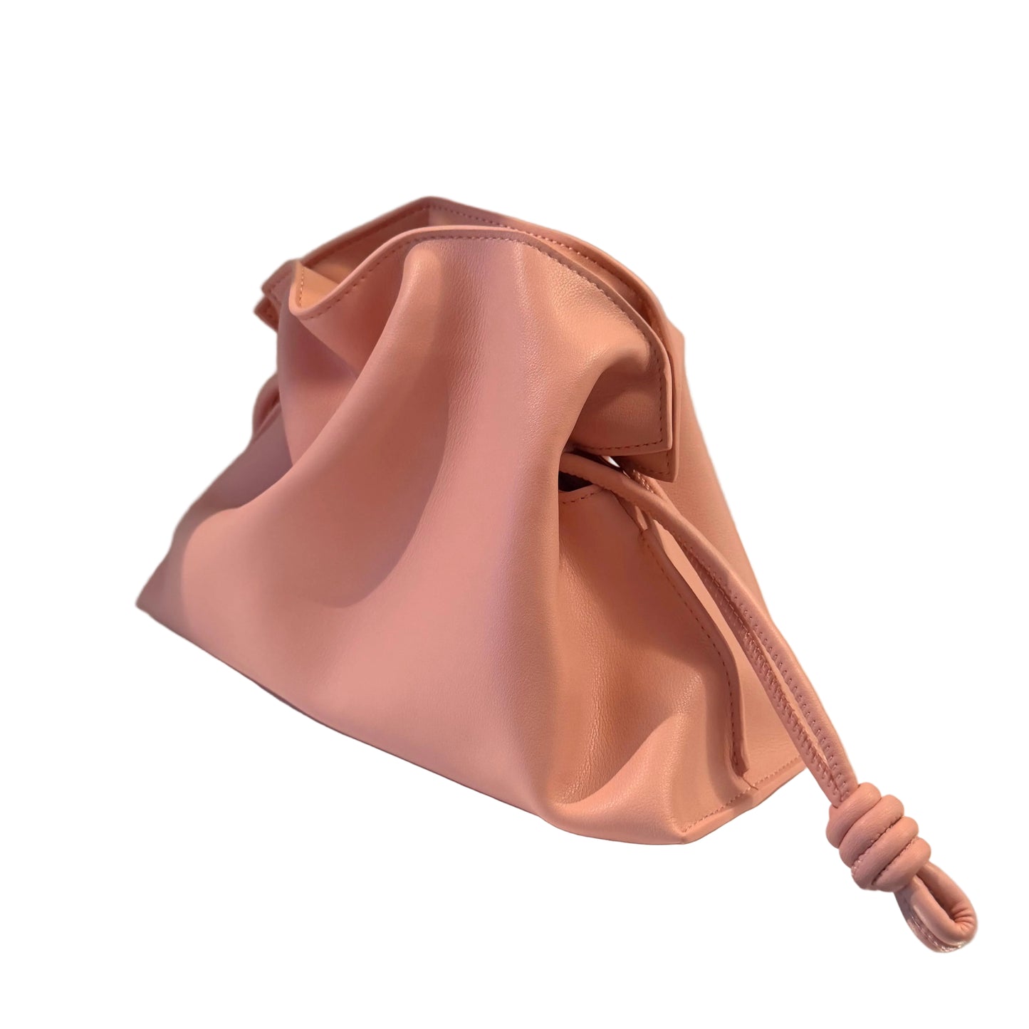 Pink drawstring bag on a white surface with a gray background