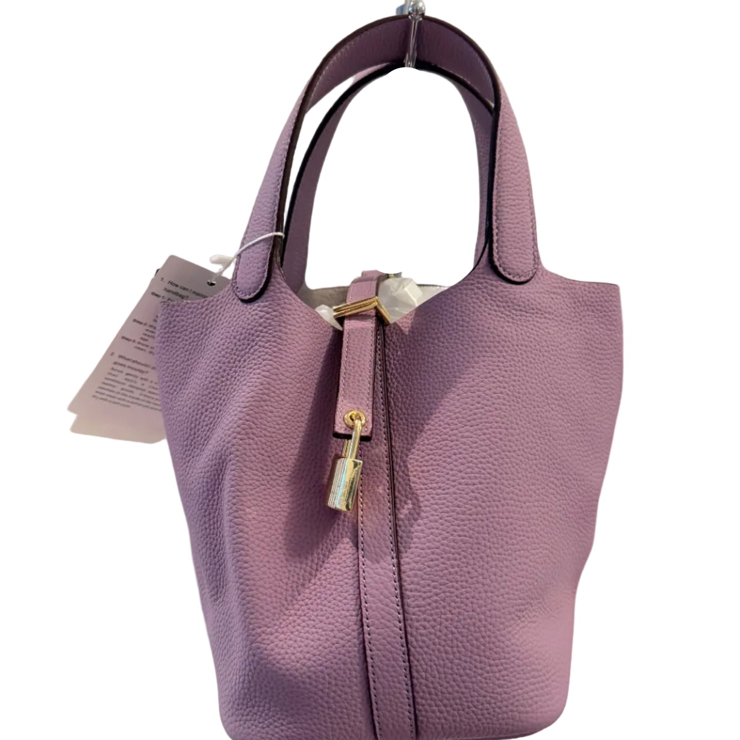 Purple handbag with a visible tag on a light gray background