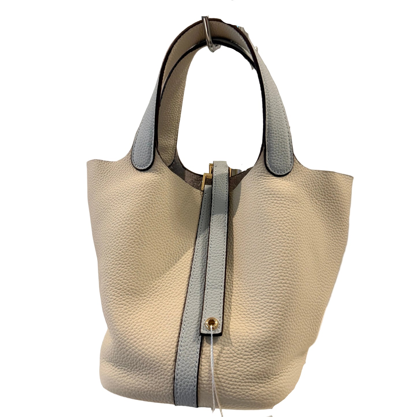 Beige handbag with a black strap on a gray background