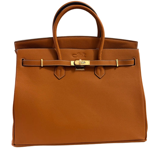 Brown leather handbag with gold hardware on a light gray background