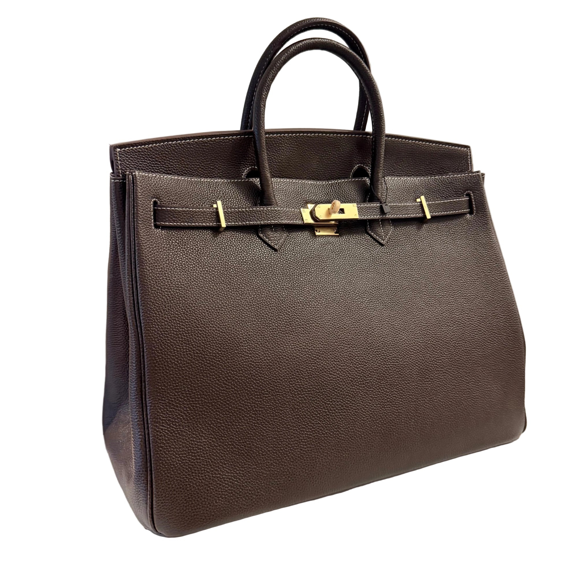 Brown leather handbag with gold hardware on a light gray background