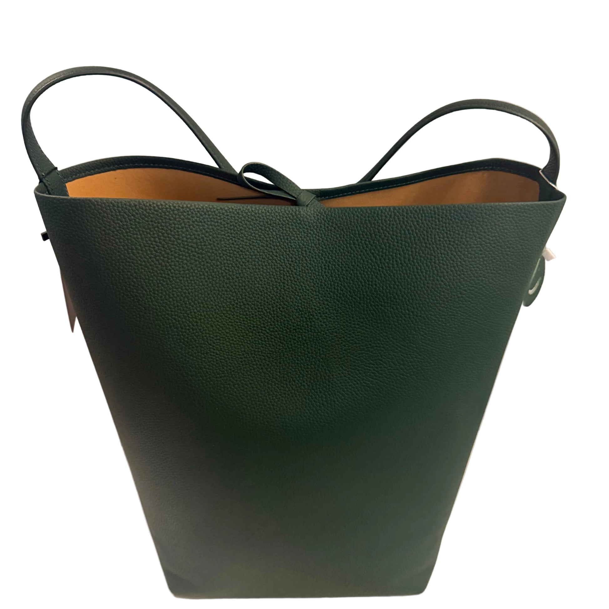 Green leather handbag on a white surface with a neutral background
