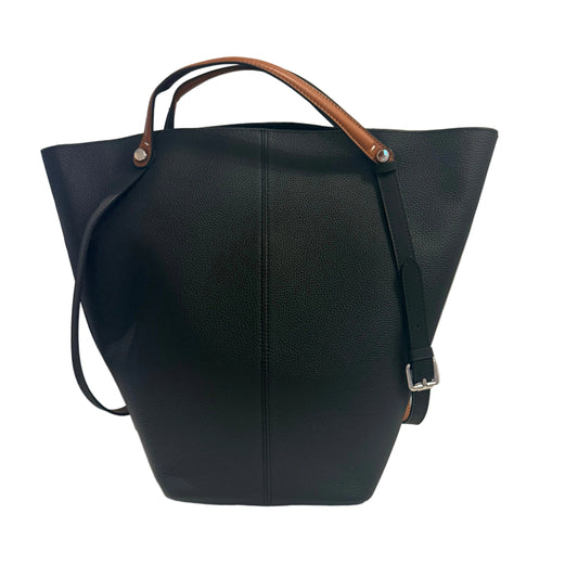 Black leather handbag with brown handle on a light gray background