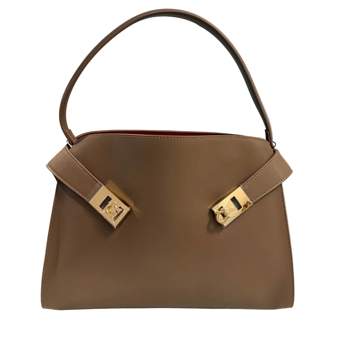Brown handbag with gold hardware on a light gray background