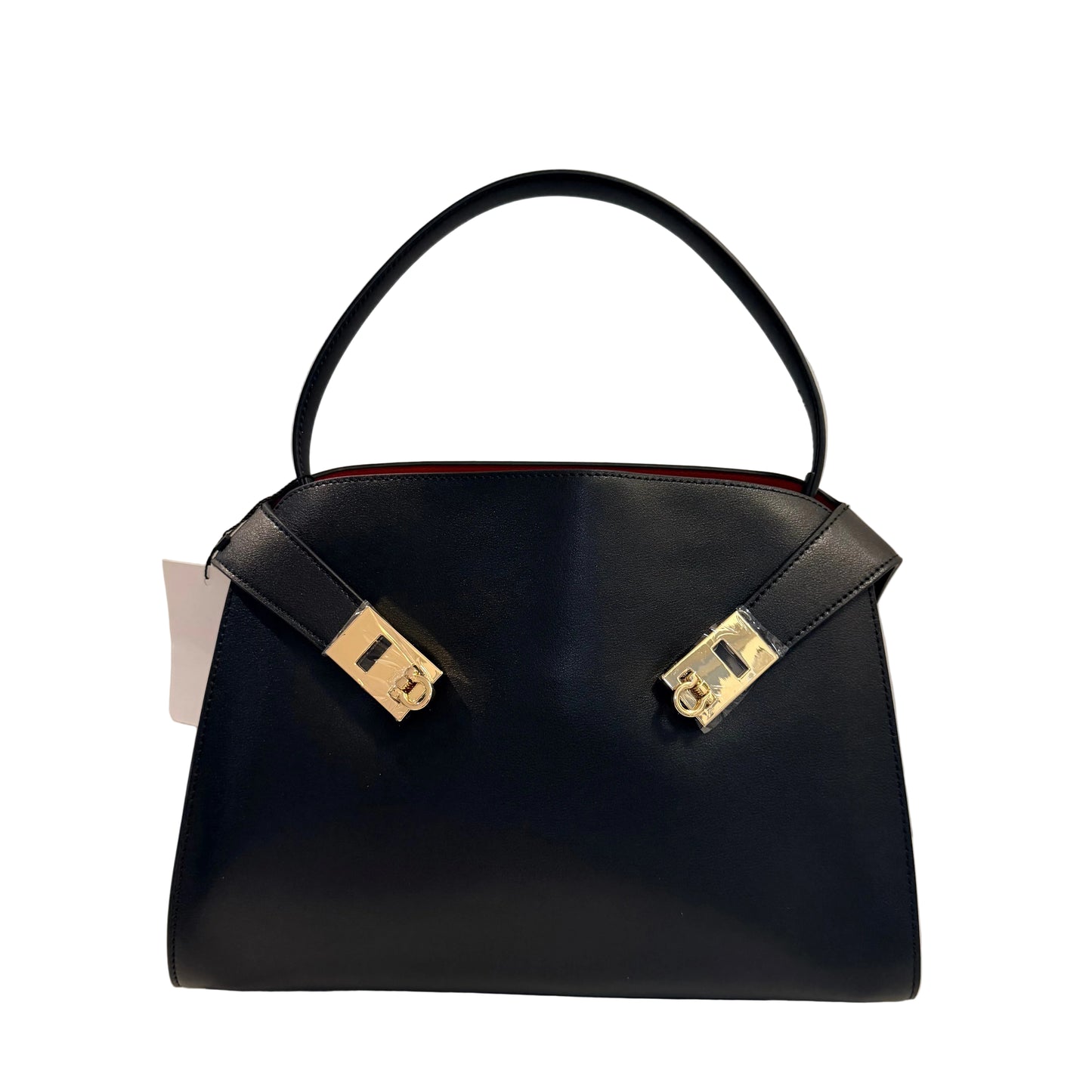 Black handbag with gold accents on a light gray background
