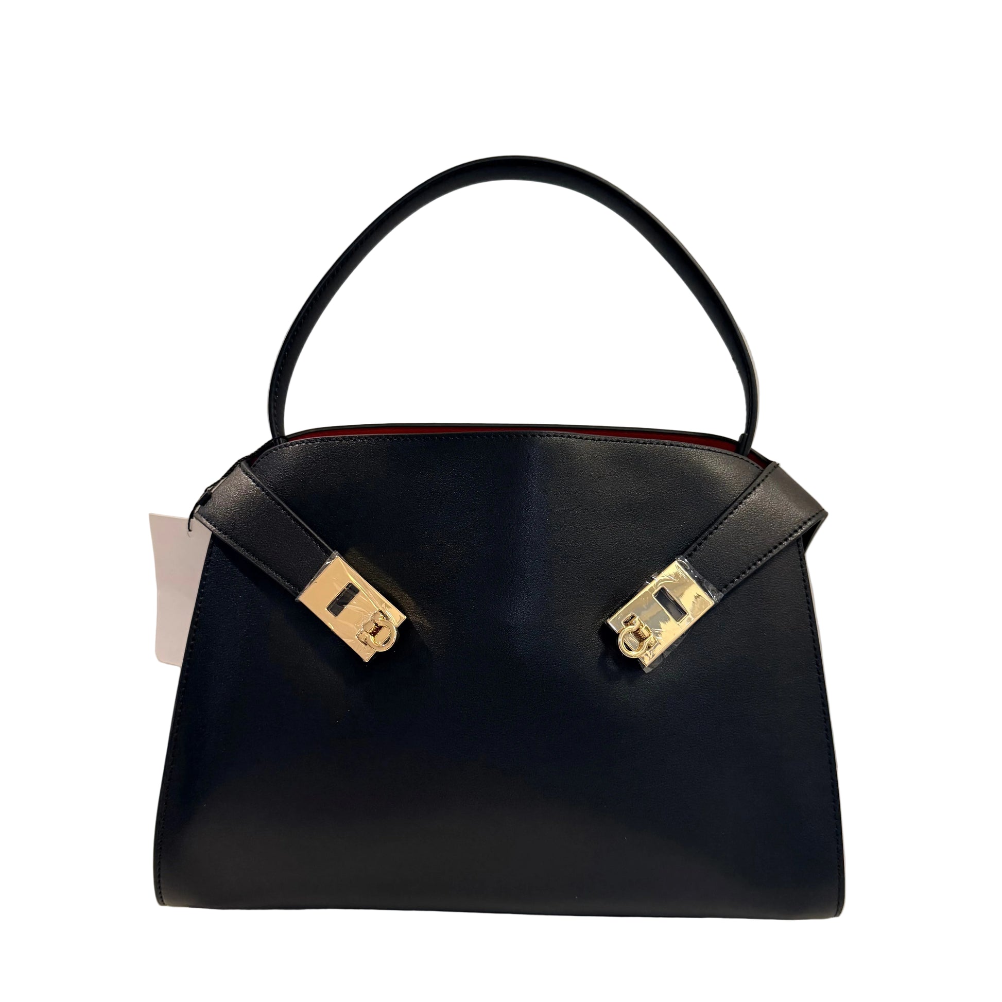 Black handbag with gold accents on a light gray background
