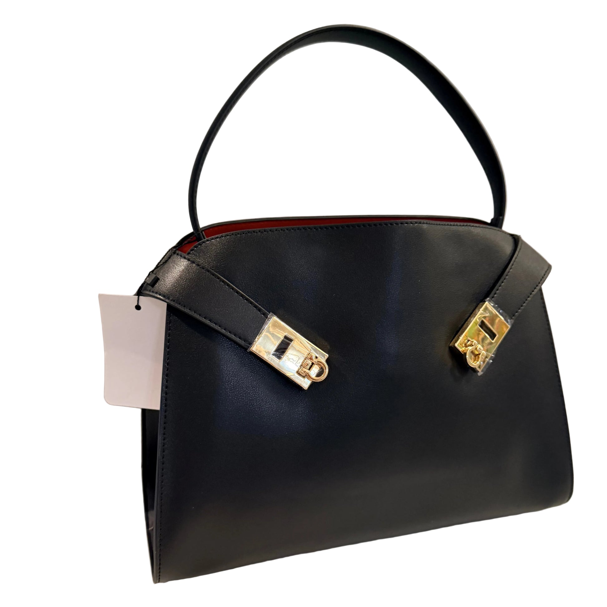 Black handbag with gold accents on a light gray background