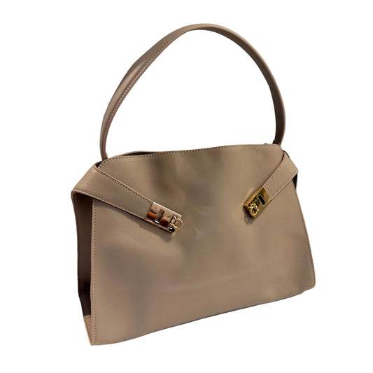 Beige handbag with a gold clasp on a white surface with a gray background