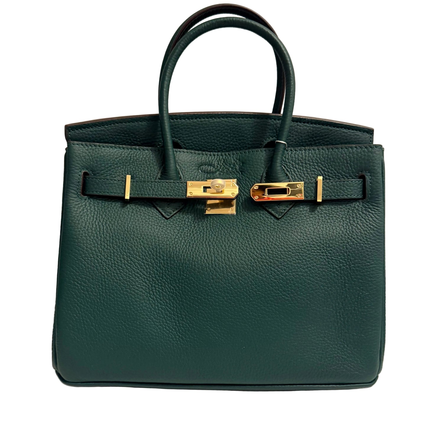 Green handbag with gold hardware on a beige background