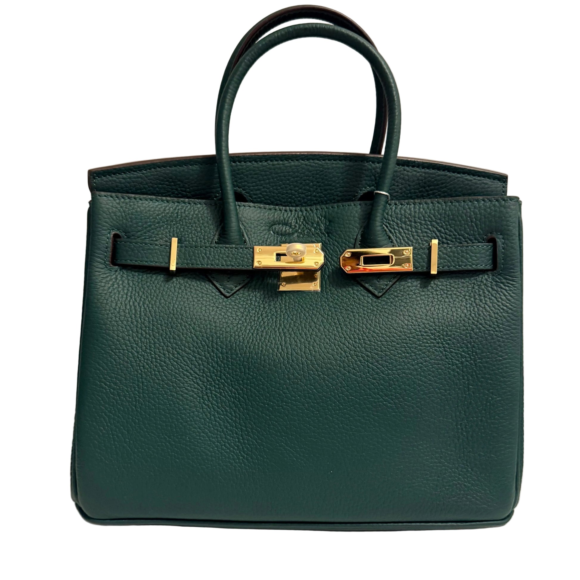 Green handbag with gold hardware on a beige background