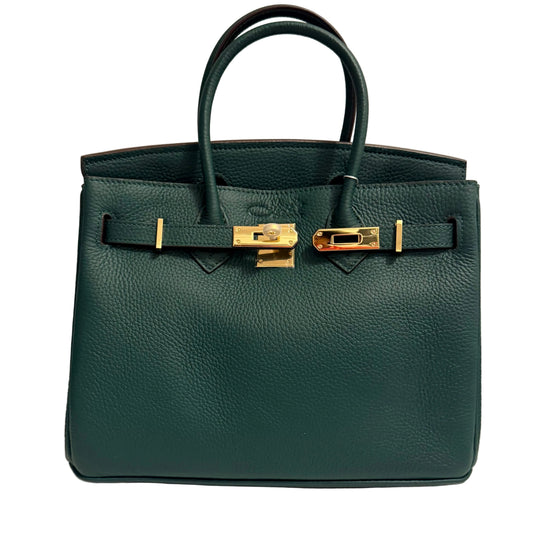 Green handbag with gold hardware on a beige background