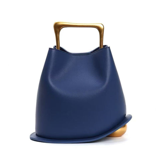 Blue handbag with a gold handle on a white background
