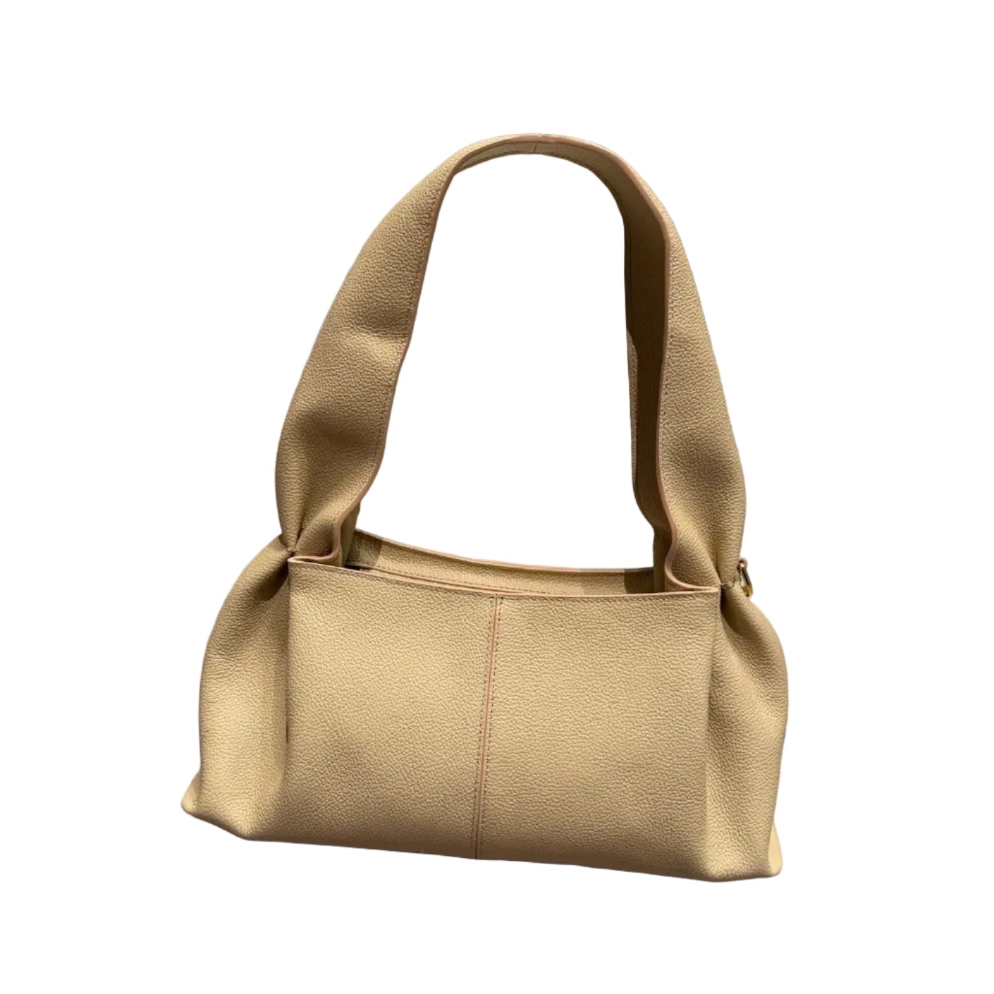 Beige handbag on a wooden floor with a neutral background