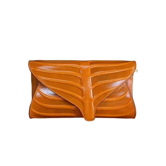 Three leaf-shaped clutches in green, brown, and red colors, displayed on a wooden surface.