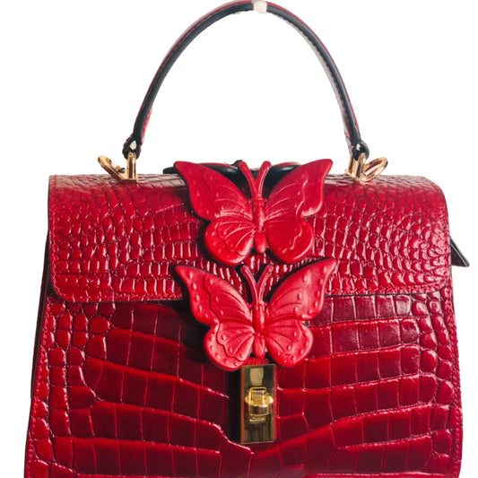 Red handbag with butterfly designs on a white background
